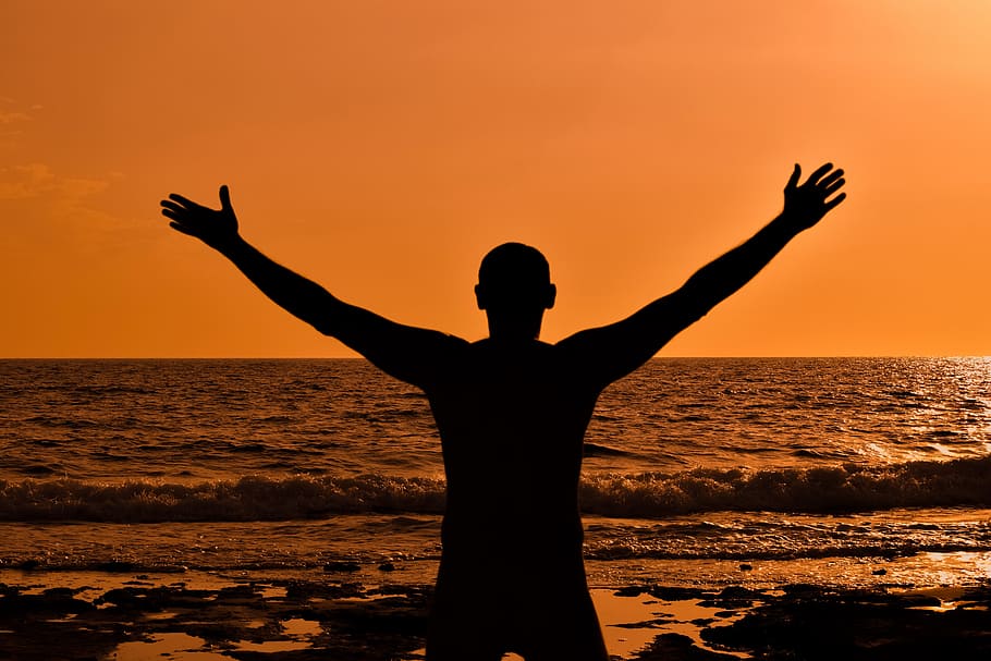 silhouette photo of man standing on seashore, sunset, dusk HD wallpaper