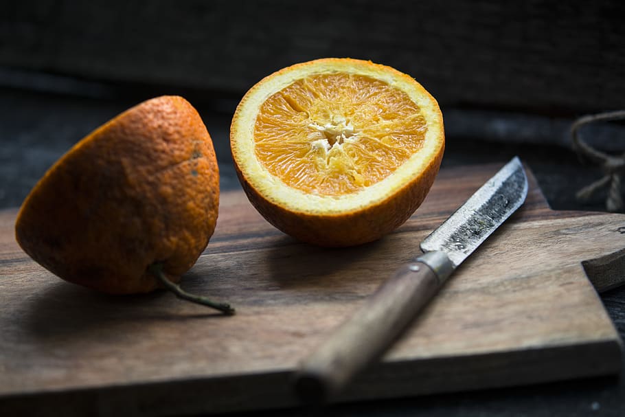 shallow focus photography of sliced lemon beside knife, sliced of orange fruit beside knife on top of chopping table HD wallpaper