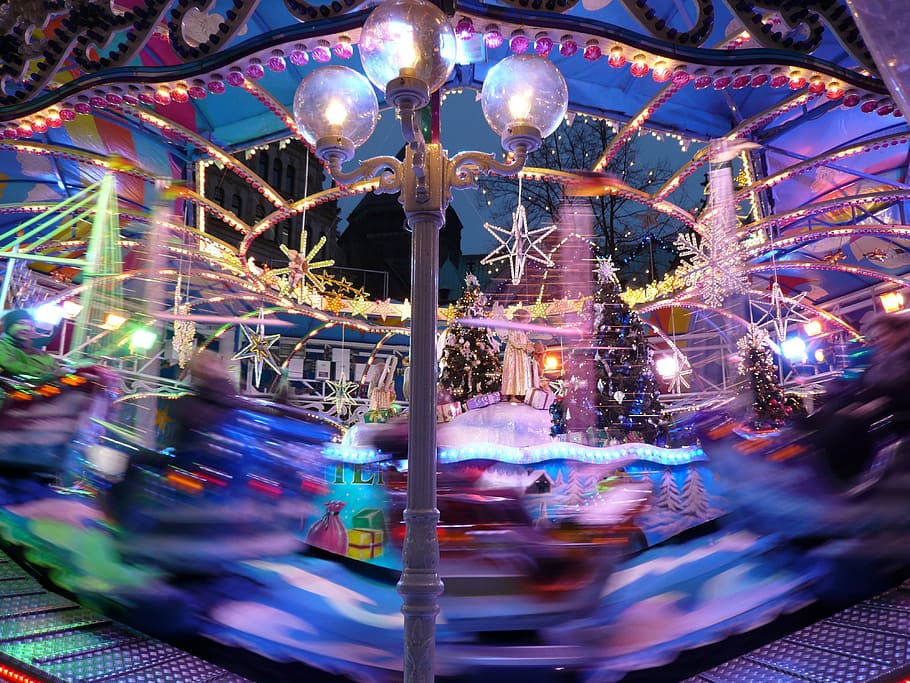 carousel with christmas tress, year market, folk festival, colorful