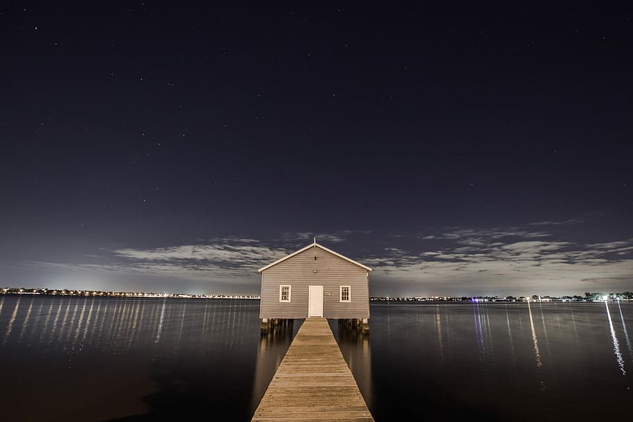gray wooden house beside wooden dock in between body of water HD wallpaper