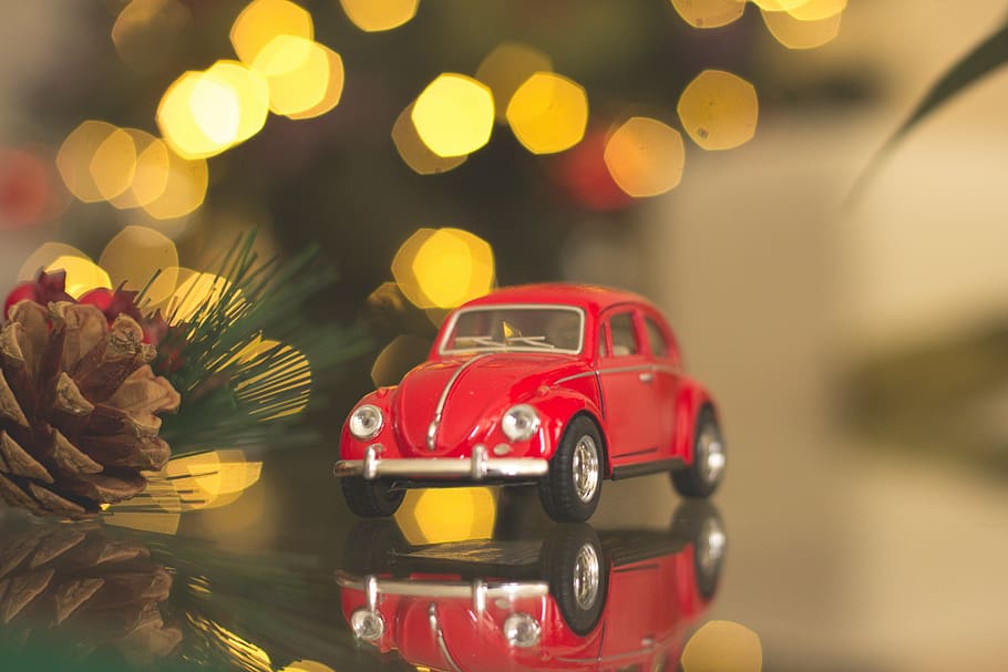 red Volkswagen car die-cast model on table, tilt-shift photography of red beetle car toy on mirrored surface, HD wallpaper