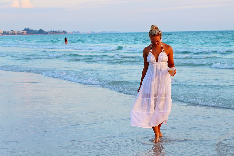 woman in white halter-strap dress walking on seashore during daytime, HD wallpaper