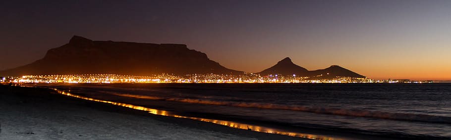seashore and view of lighted mountain, table mountain, cape town