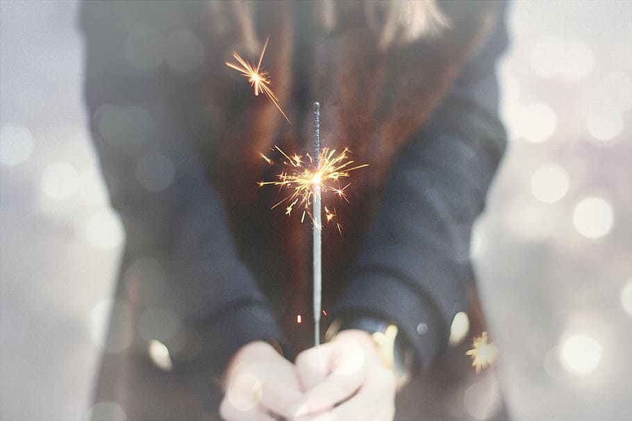 person holding lighted firecracker, sparkler, bokeh, celebration HD wallpaper