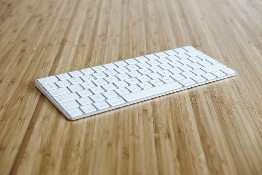 silver and white keyboard on brown wooden surface, Apple wireless Keyboard HD wallpaper