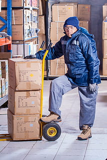 man wearing blue jacket beside yellow hand truck, stevedore HD wallpaper