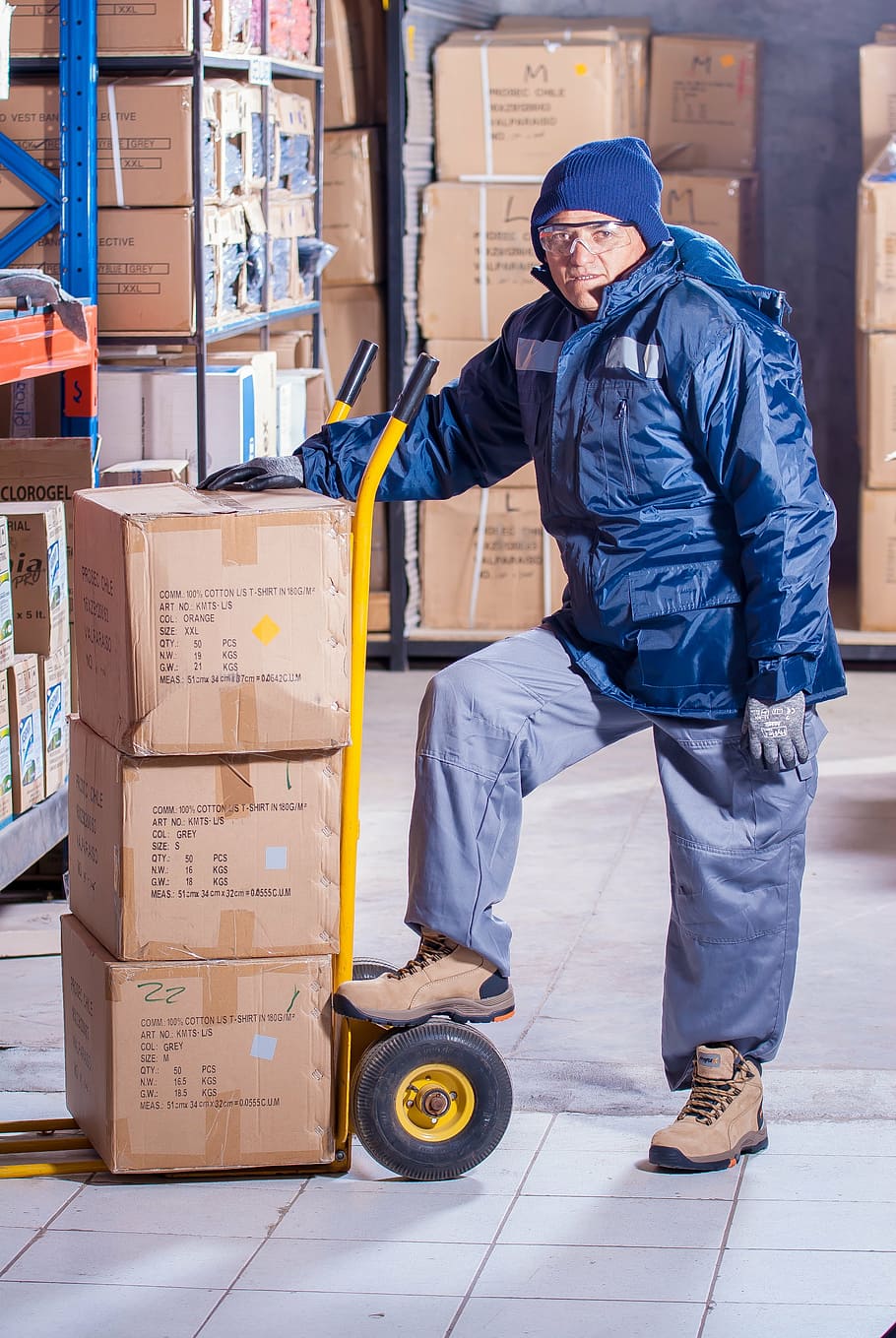 man wearing blue jacket beside yellow hand truck, stevedore HD wallpaper