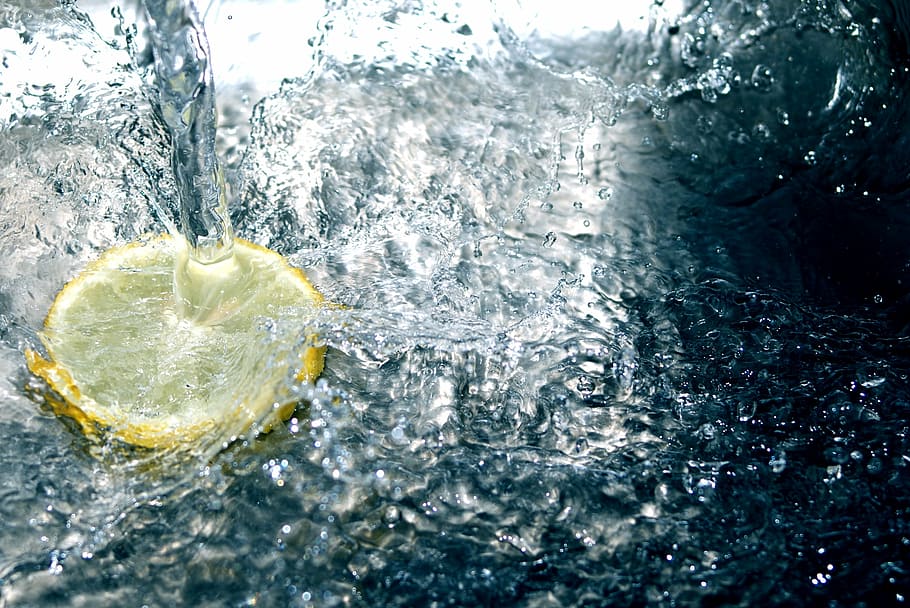 sliced American lemon on water, clear, yellow, a splash of, white