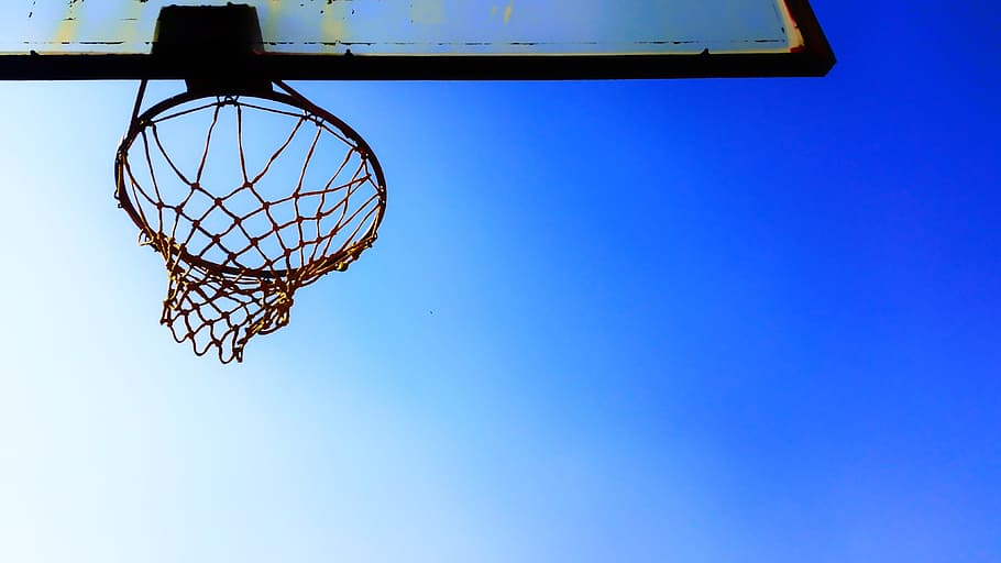 Premium Photo  Basketball hoop in a blue day and overcast sky, added color  filter