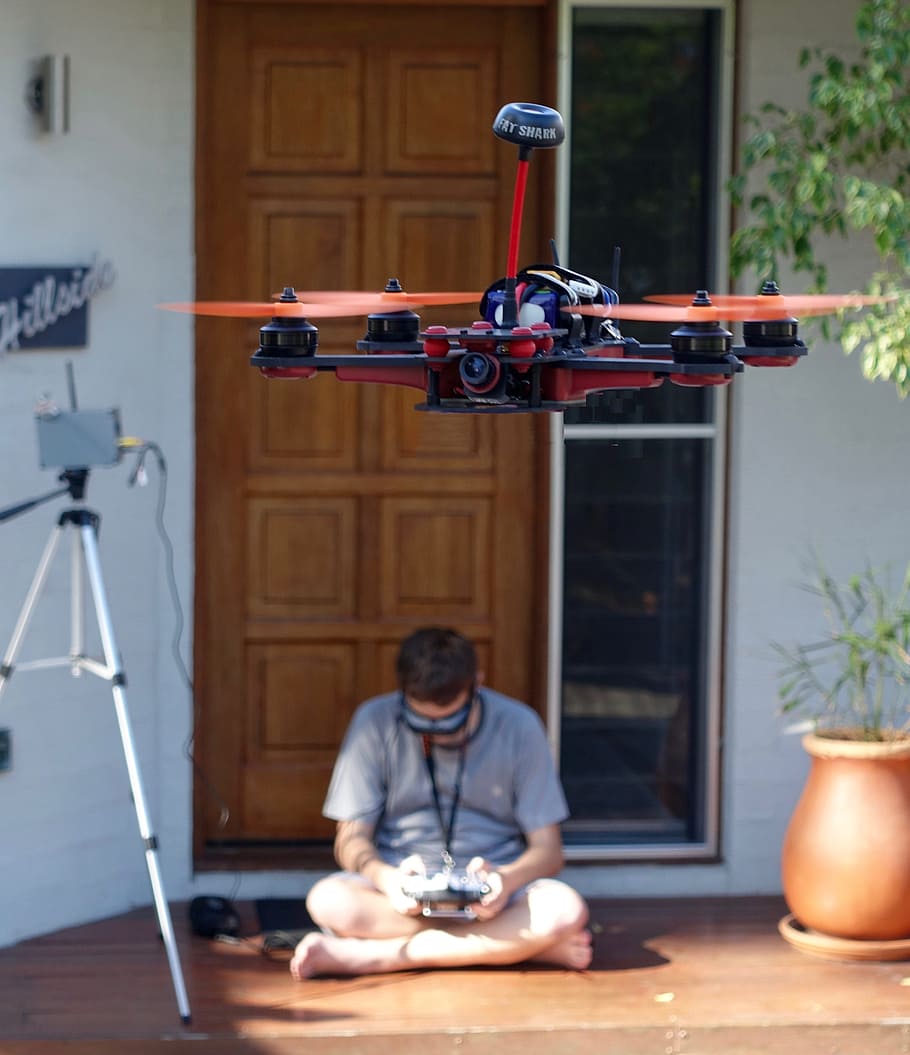 man sitting on floor beside tripod, drone, quadcopter, control HD wallpaper
