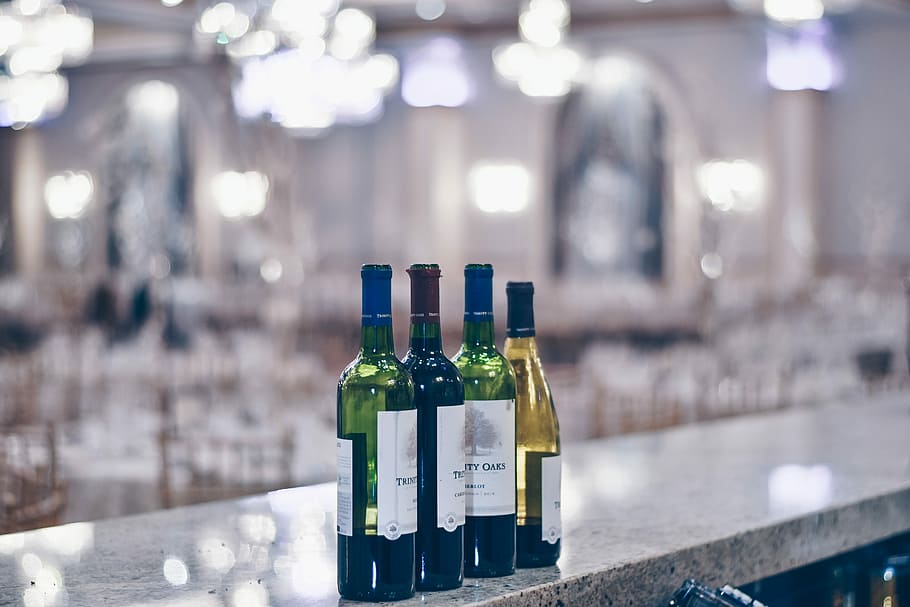 shallow focus photography of wine bottles, four glass bottles on selective focus photo HD wallpaper