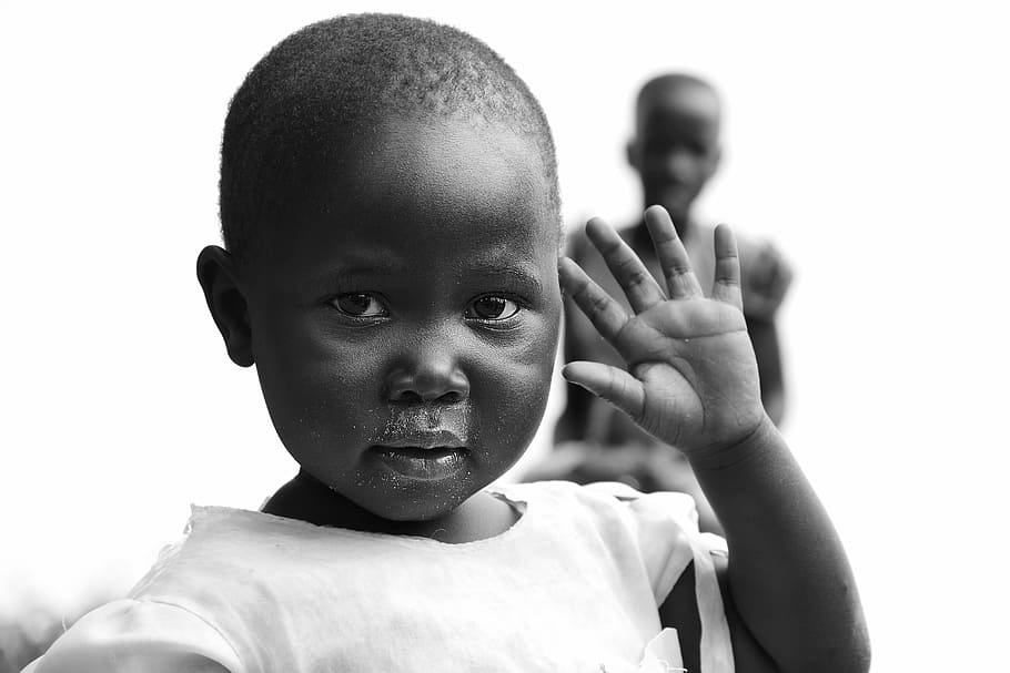 grayscale photo of toddler raising left hand, children of uganda