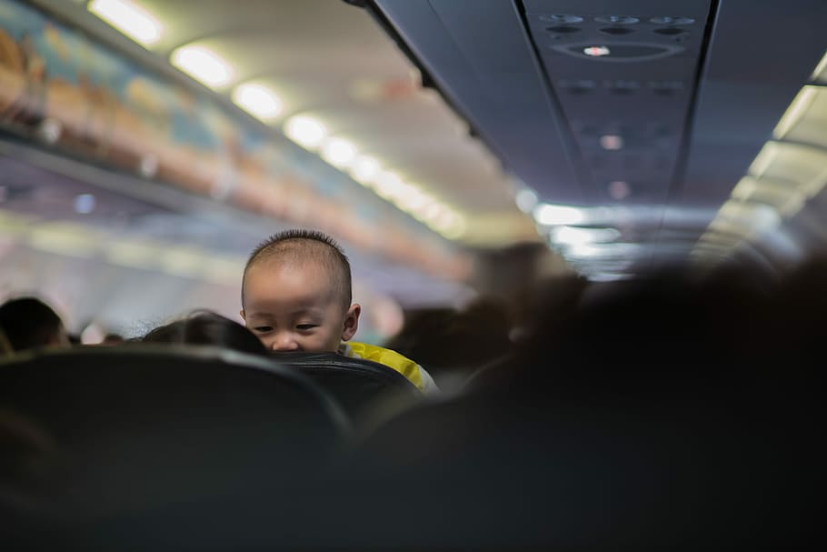 baby in passenger plane, toddler sneaking to the passenger in there back, HD wallpaper