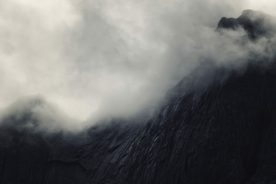 mountain surrounded by cloud formation, low angle photography of black fogging mountain HD wallpaper
