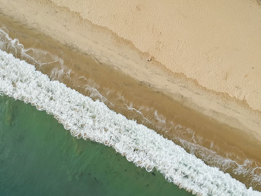aerial photo of seashore during daytime, bird's eye view photo of waves crashing on shore during daytime HD wallpaper
