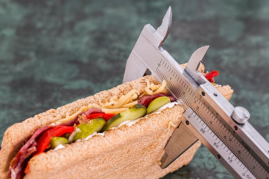 sandwich being measured by gray vernier caliper, diet, calorie counter
