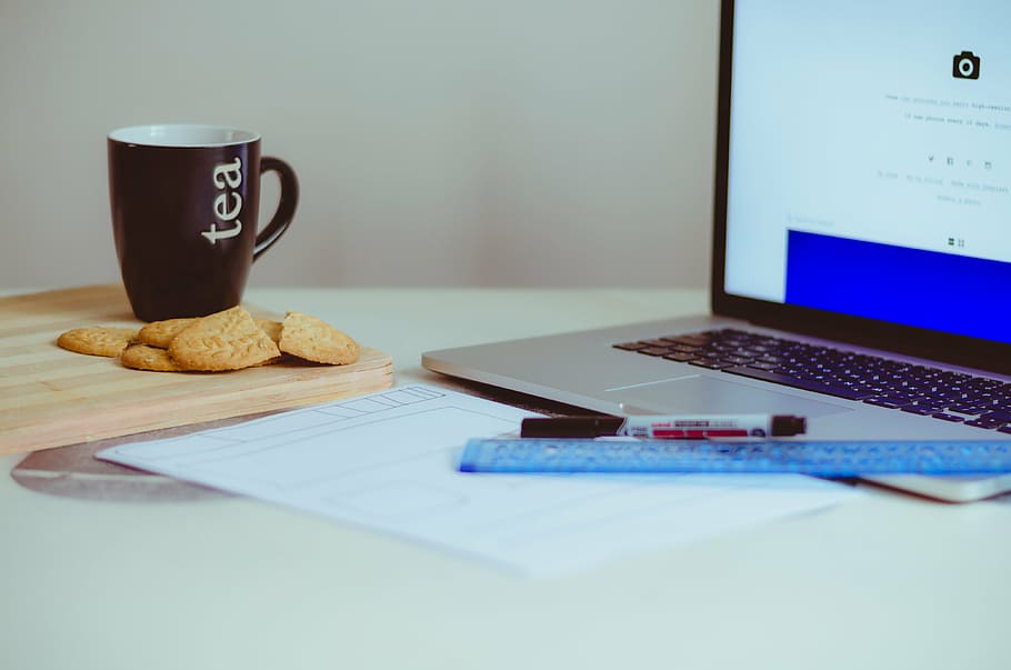 turned-on MacBook Pro near mug, laptop, apple, keyboard, technology HD wallpaper