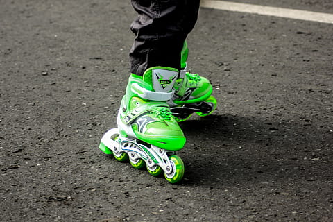 person wearing pair of green inline skates, person using green inline skates HD wallpaper