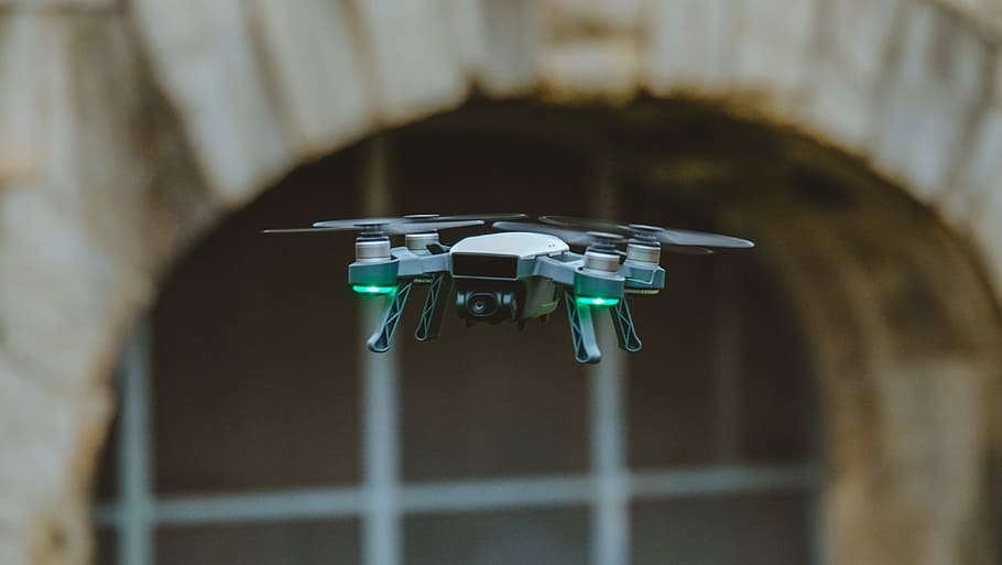selective focus photo of black quadcopter, flying green and black quadcopter drone HD wallpaper