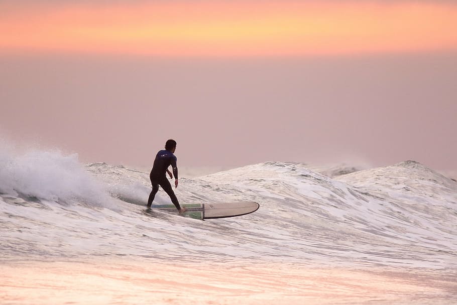 man riding surfboard, sunset, surfer, surfing, ocean, waves HD wallpaper