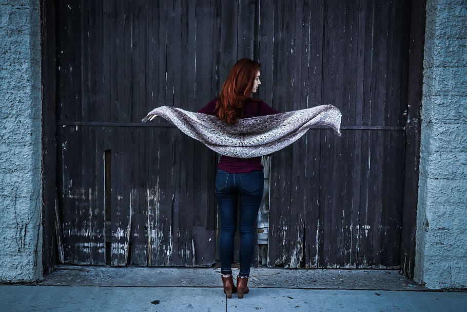 Woman Holding Gray Shawl While Spreading Her Arms Infront of Brown Wooden Door HD wallpaper