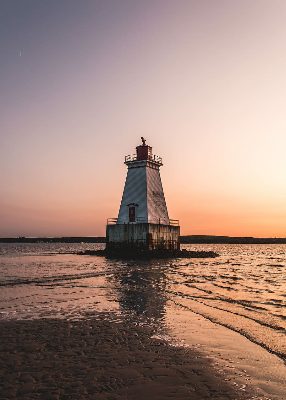 white lighthouse surrounded by body of water, gray lighthouse near seashore during sunset HD wallpaper
