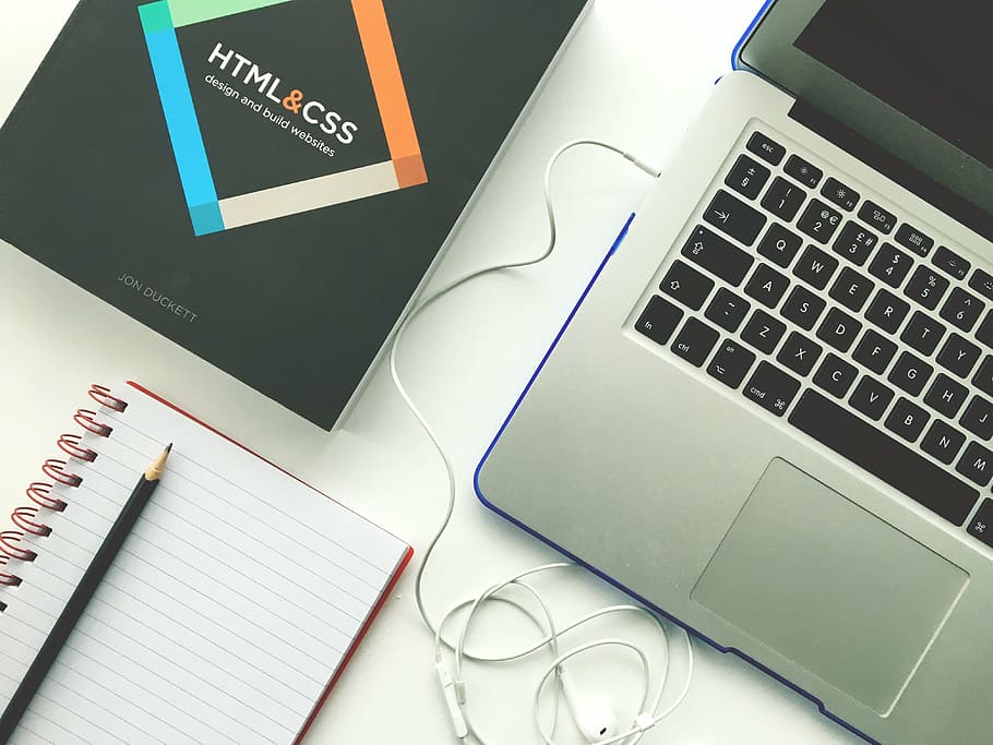 MacBook Pro beside spiral notebook, web design, laptop, html HD wallpaper