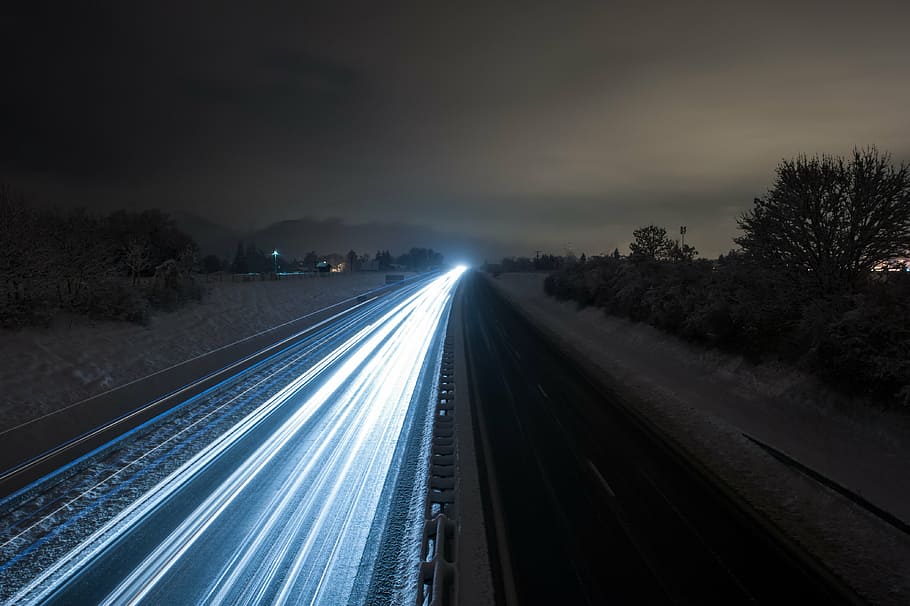 time-lapsed photography of vehicle running on road during nighttime HD wallpaper