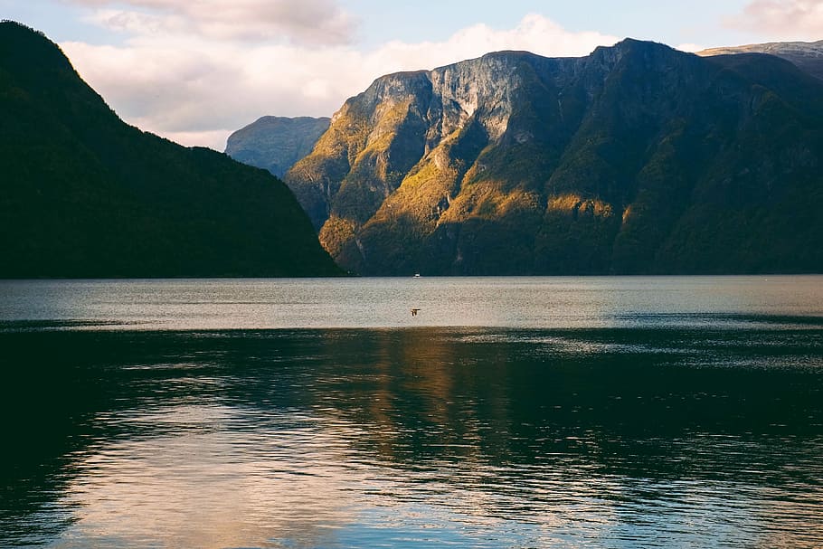 calm body of water and mountain, body of water during daytime HD wallpaper