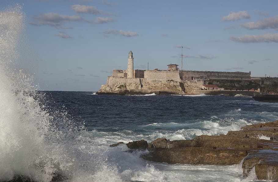 lighthouse near calm body of water, surf, crashing, castle HD wallpaper