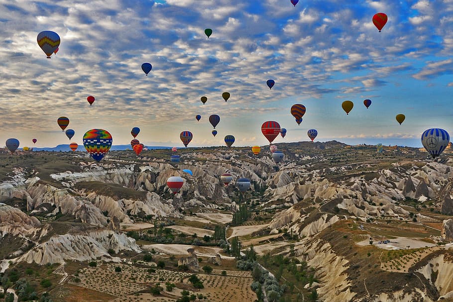 assorted color hot air balloons flying over countryside, cappadocia HD wallpaper