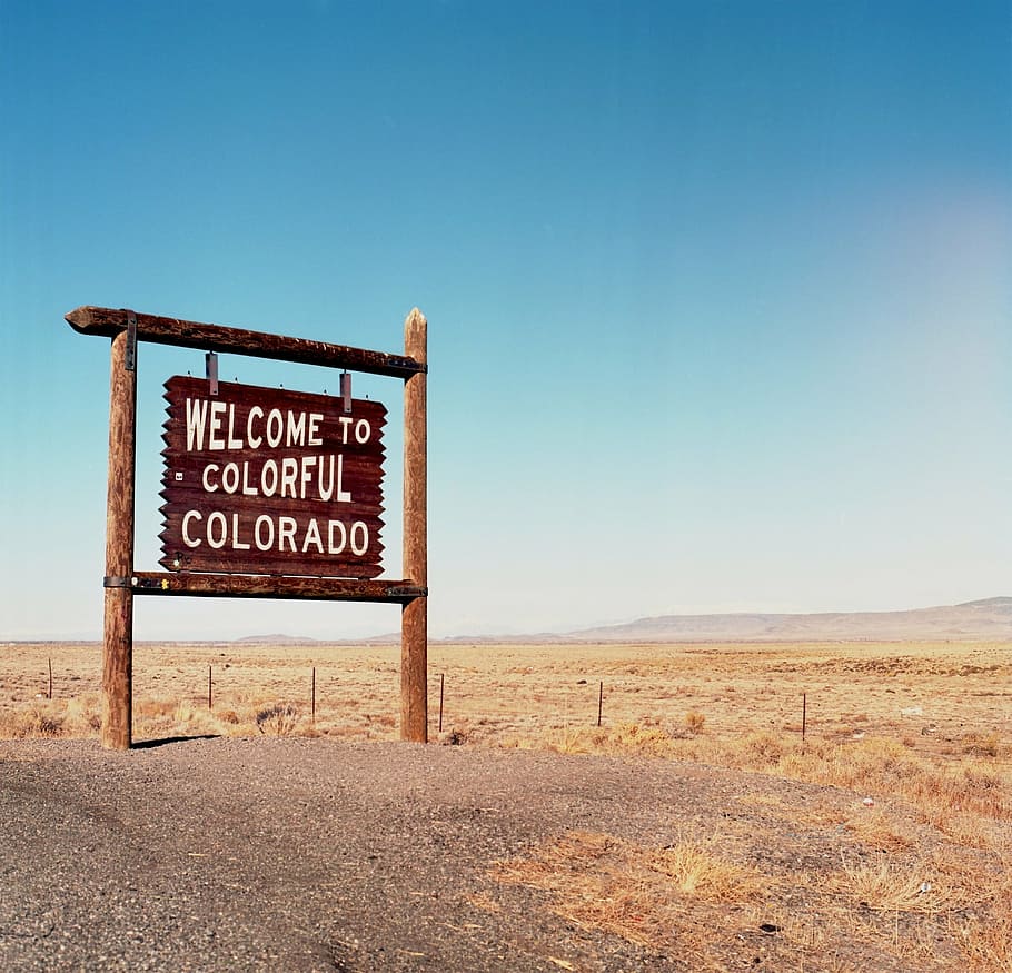 welcome to colorful Colorado signage, signpost, border, tourism
