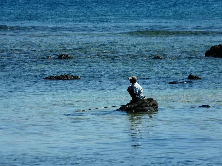 man sitting on rock in body of water, angler, mauritian, mauritius, HD wallpaper