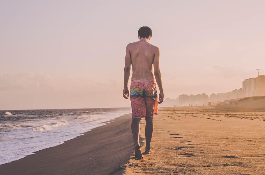 man walking beside sea shore, man walking near seashore, standing HD wallpaper