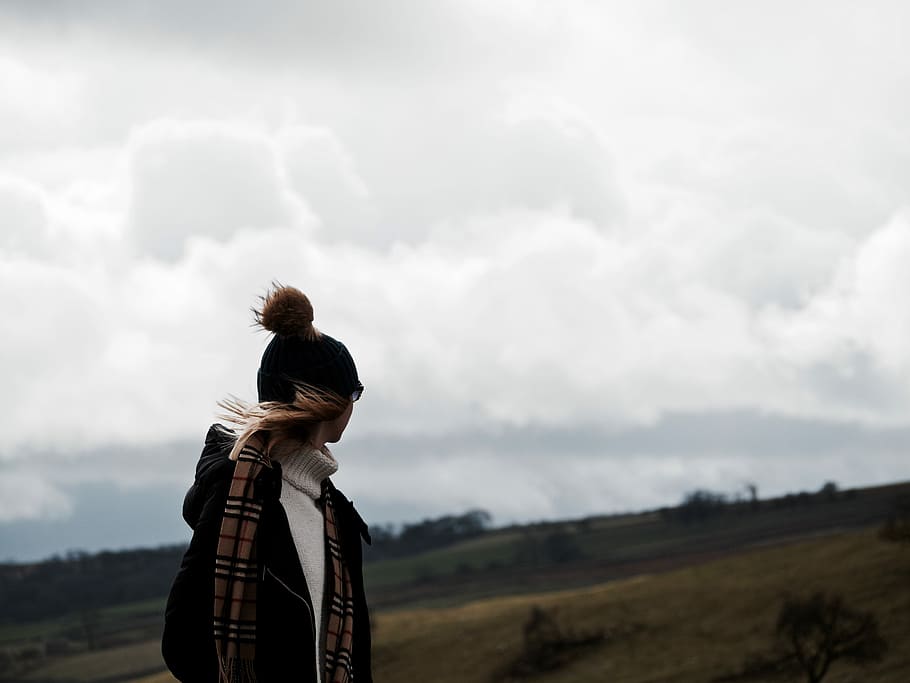 person in bobble cap and jacket with burberry scarf standing in open field area, HD wallpaper
