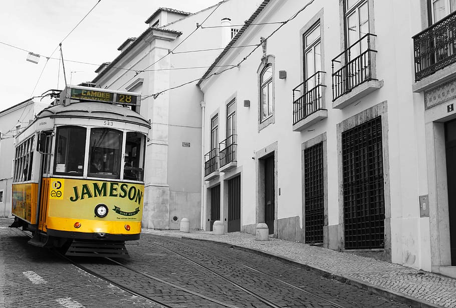 selective-color photography of Jameson tram train, yellow, lisbon