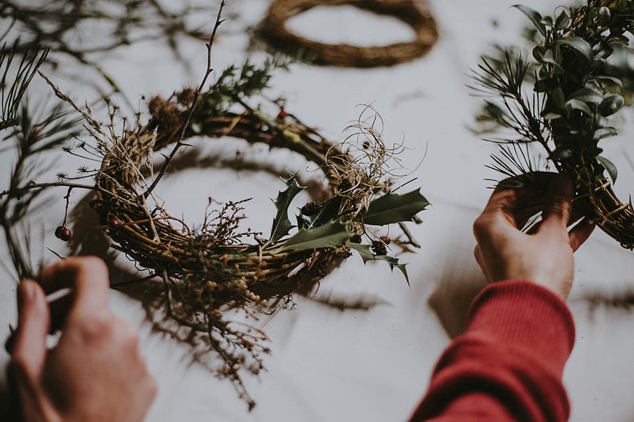 Wreath making, person holding green and brown wreath, foliage HD wallpaper