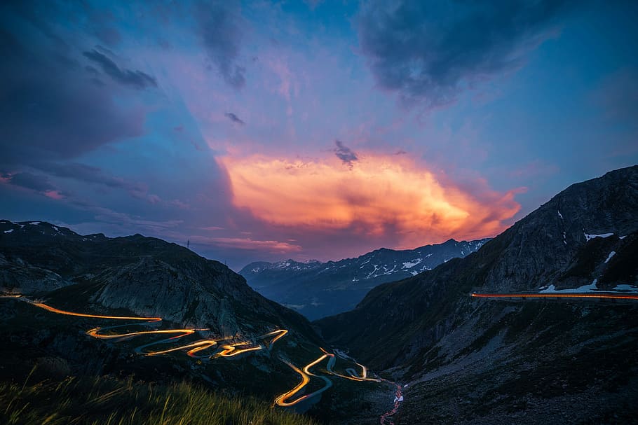 timelapse photo of zigzag road during nighttime, time lapse photo of light on road hills at dawn HD wallpaper