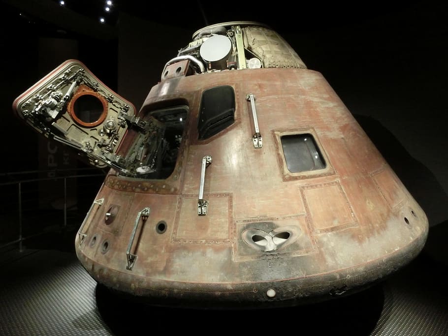 photo of brown and grey metal equipment, space capsule, apollo program