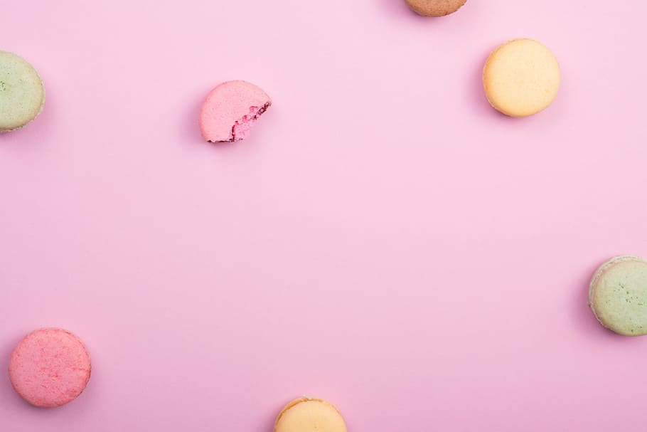 pile of French macaroons, macaroons on pink surface, macaron