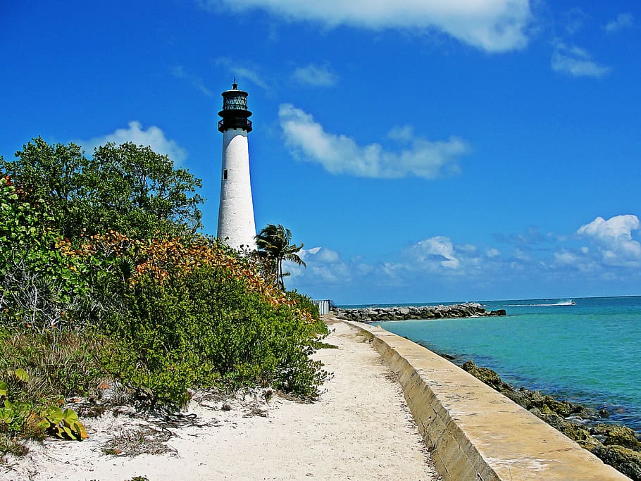 concrete lighthouse near water at daytime, farito key biscayne