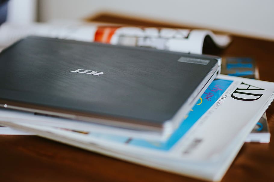 Laptop, a smartphone, magazines and cups of coffee on a table HD wallpaper