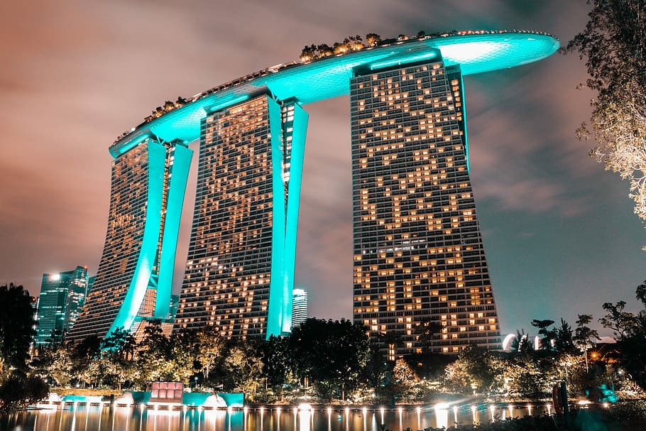 photo of high rise building, gray concrete building with yellow lights HD wallpaper
