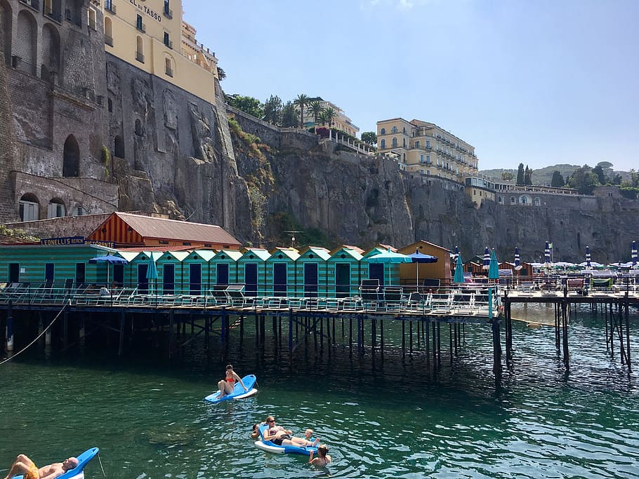 people on floaters sunbathing during daytime, sorrento, amalfi coast