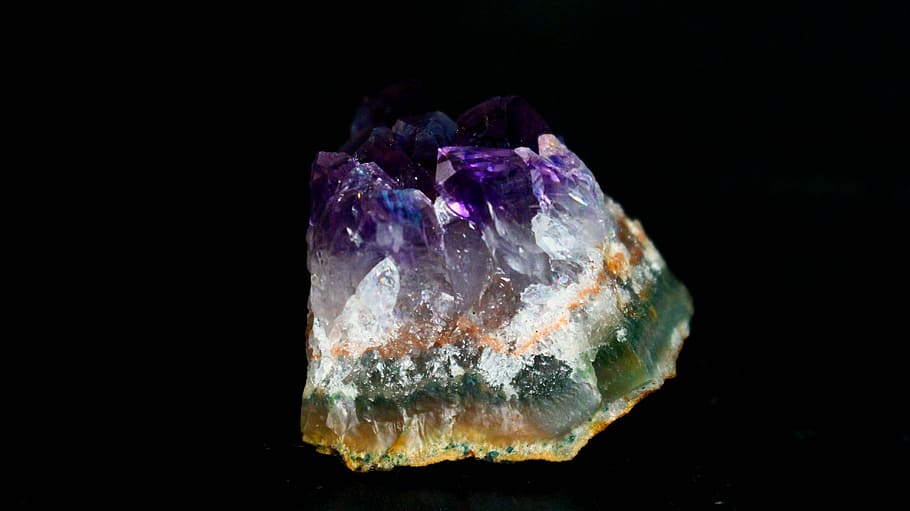 green, white, and purple stone with black background, amethyst