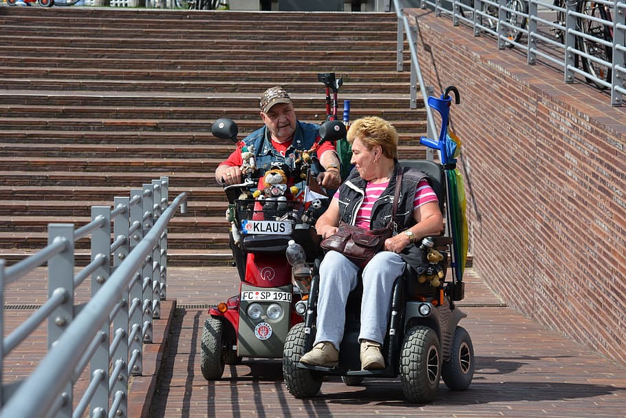 man and woman riding power chairs, hamburg, st pauli, wheelchair users, HD wallpaper