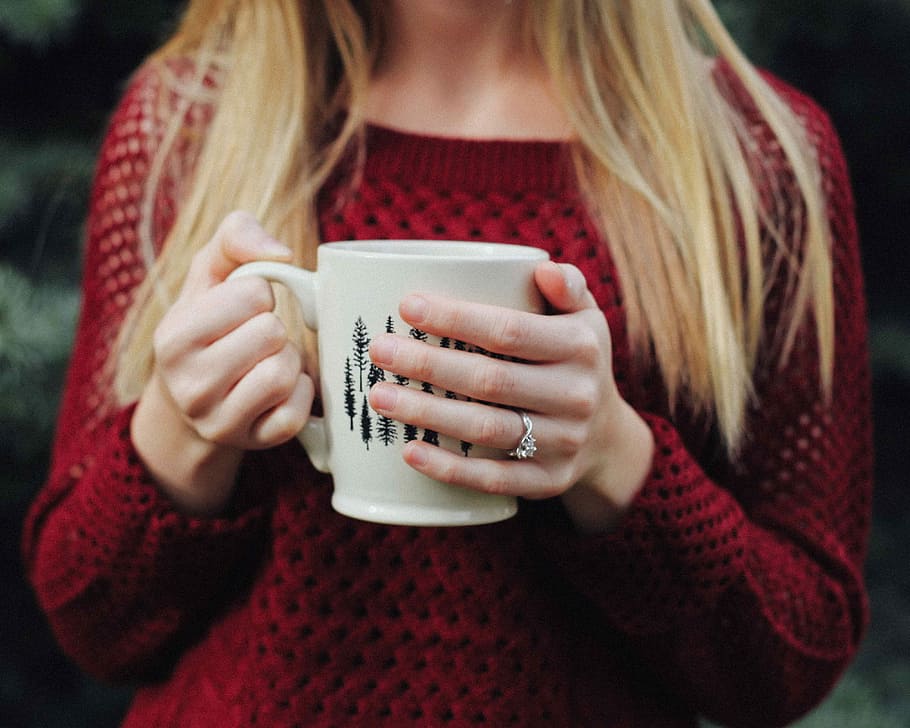 woman wearing red sweater holding white and black ceramic mug, woman wearing red sweater holding white ceramic mug HD wallpaper