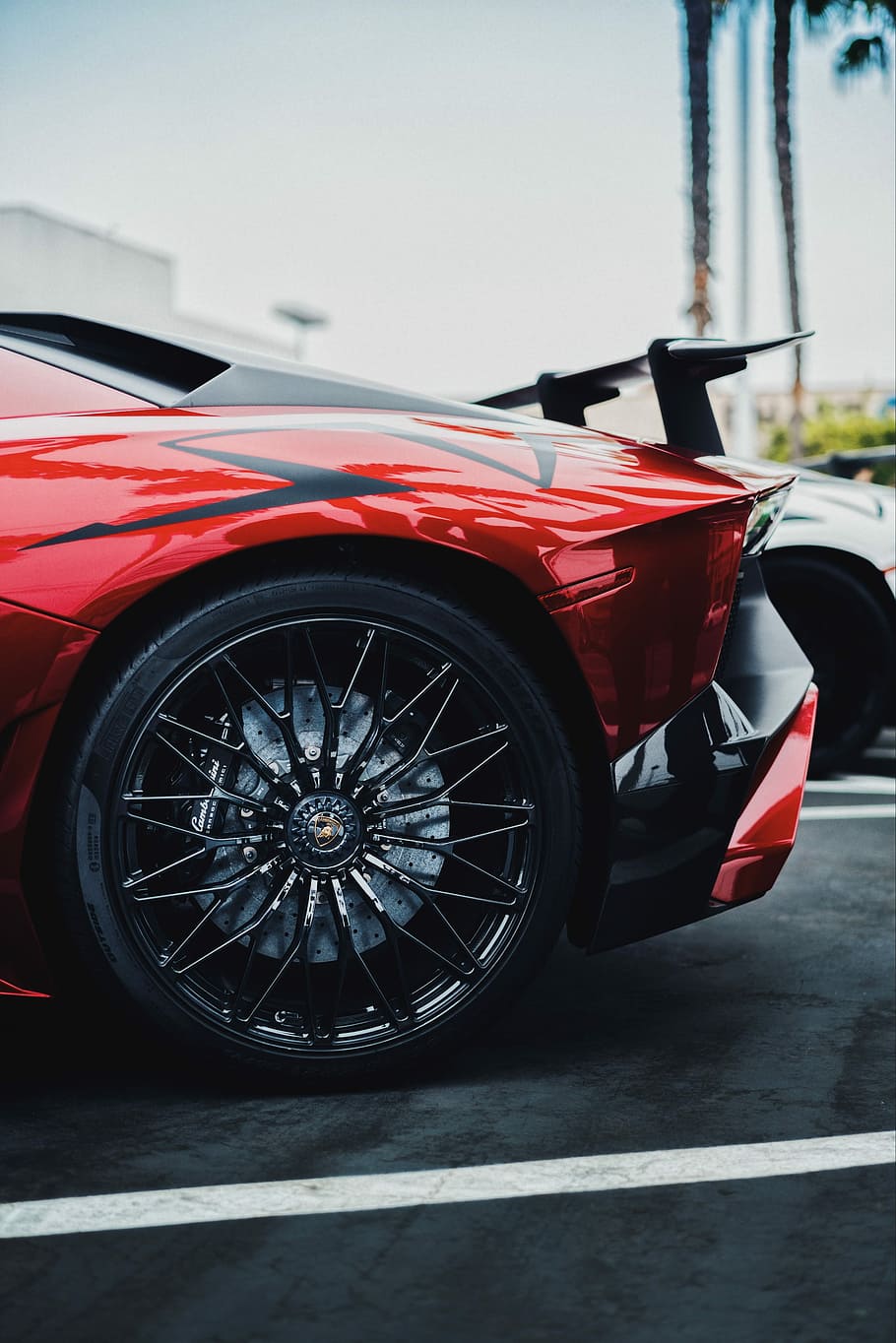 black and red Lamborghini Aventador SV rear left side, red car with spoiler