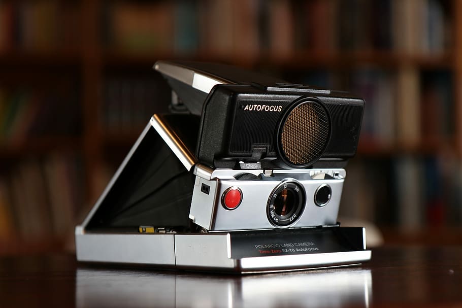 black and gray Polaroid camera, tilt shift lens photography of land camera