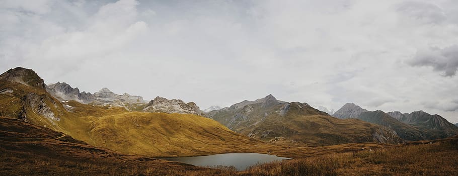 mountain at cloudy sky, brown mountain over horizon, rock, lake HD wallpaper